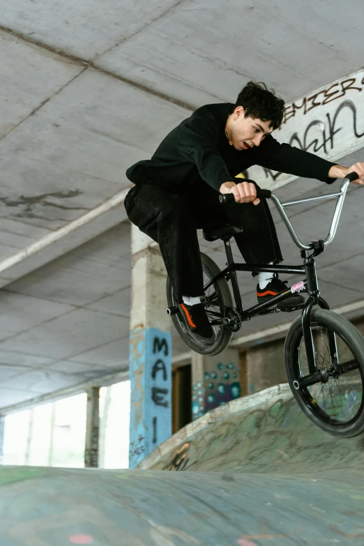 a man flying through the air on top of a bike