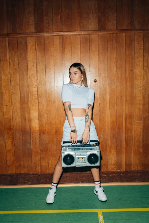 a woman holding a boombox and a radio