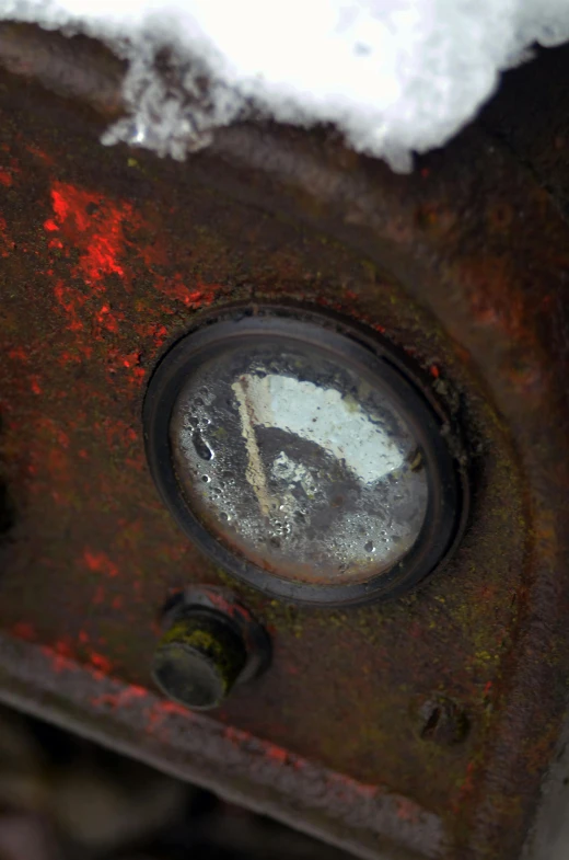 closeup of an old rusted out tire near snow