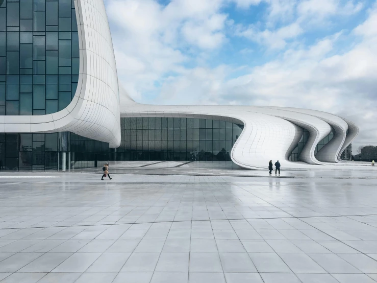 a white building that has a massive curved staircase next to it