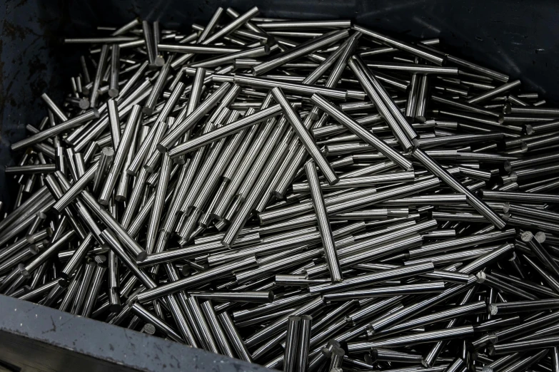 a bin full of a bunch of nails sitting next to each other