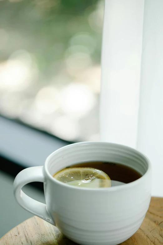 a cup of coffee with lemon and water in it