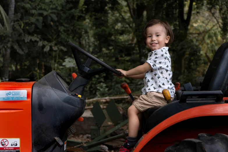 a  sitting on top of a tractor