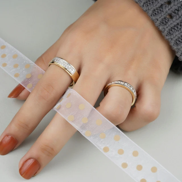 a hand with two rings on top of it and a tape