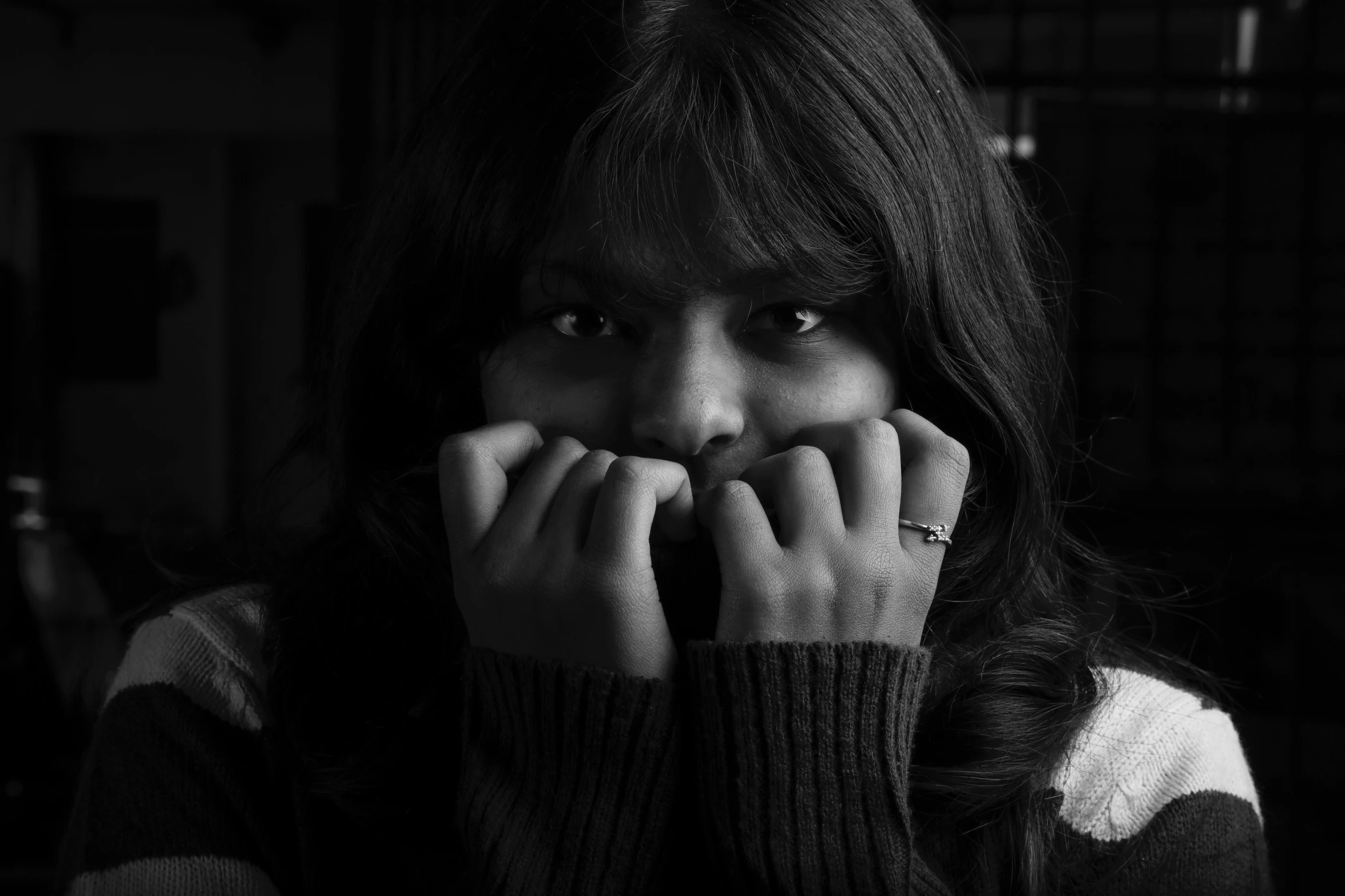 a close up of a woman covering her mouth