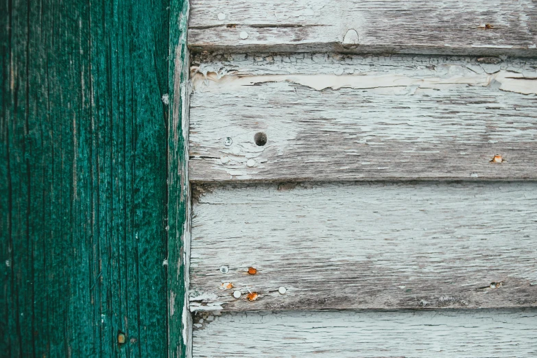 the wood is peeling off from the wall