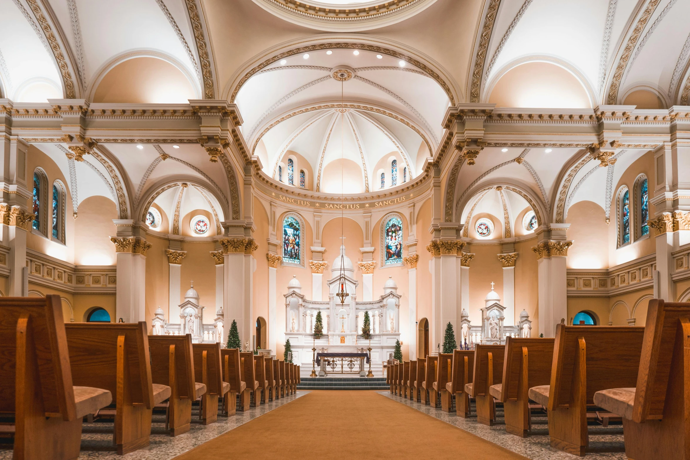 a church with vaulted ceilings, wooden pews and stained glass