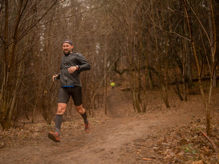 the man is running down a dirt road