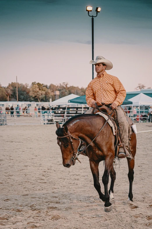 a man riding a horse across a sandy field