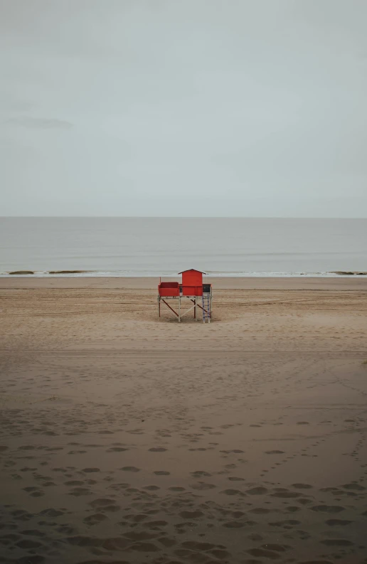 a chair that is in the sand next to water