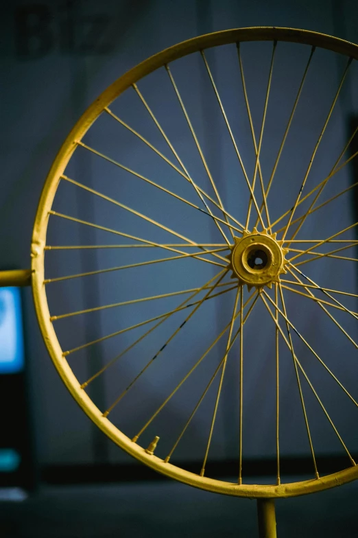 a wheel with spokes and a clock on the background