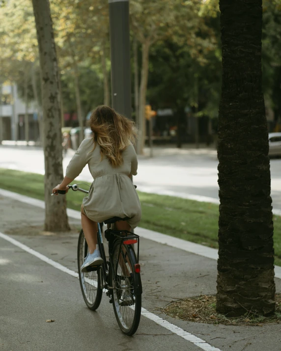 the woman is riding her bike on the street