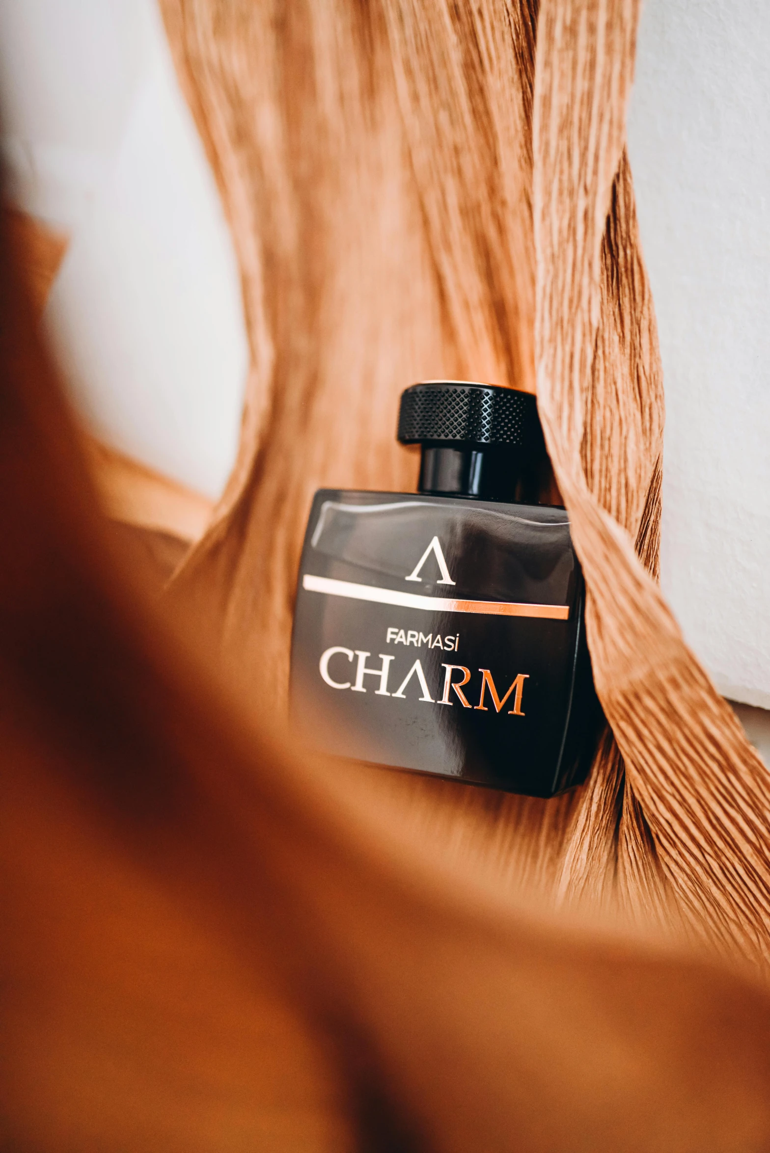 a bottle of charm sitting on top of a wooden table