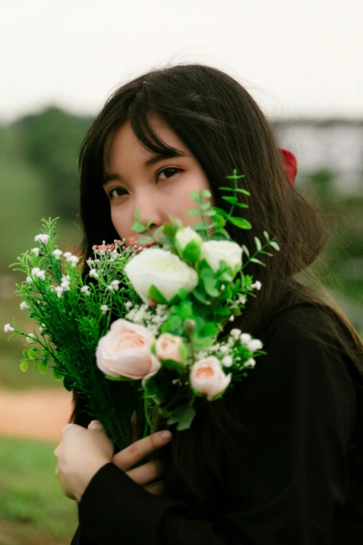 woman holding a bouquet of flowers in her hands