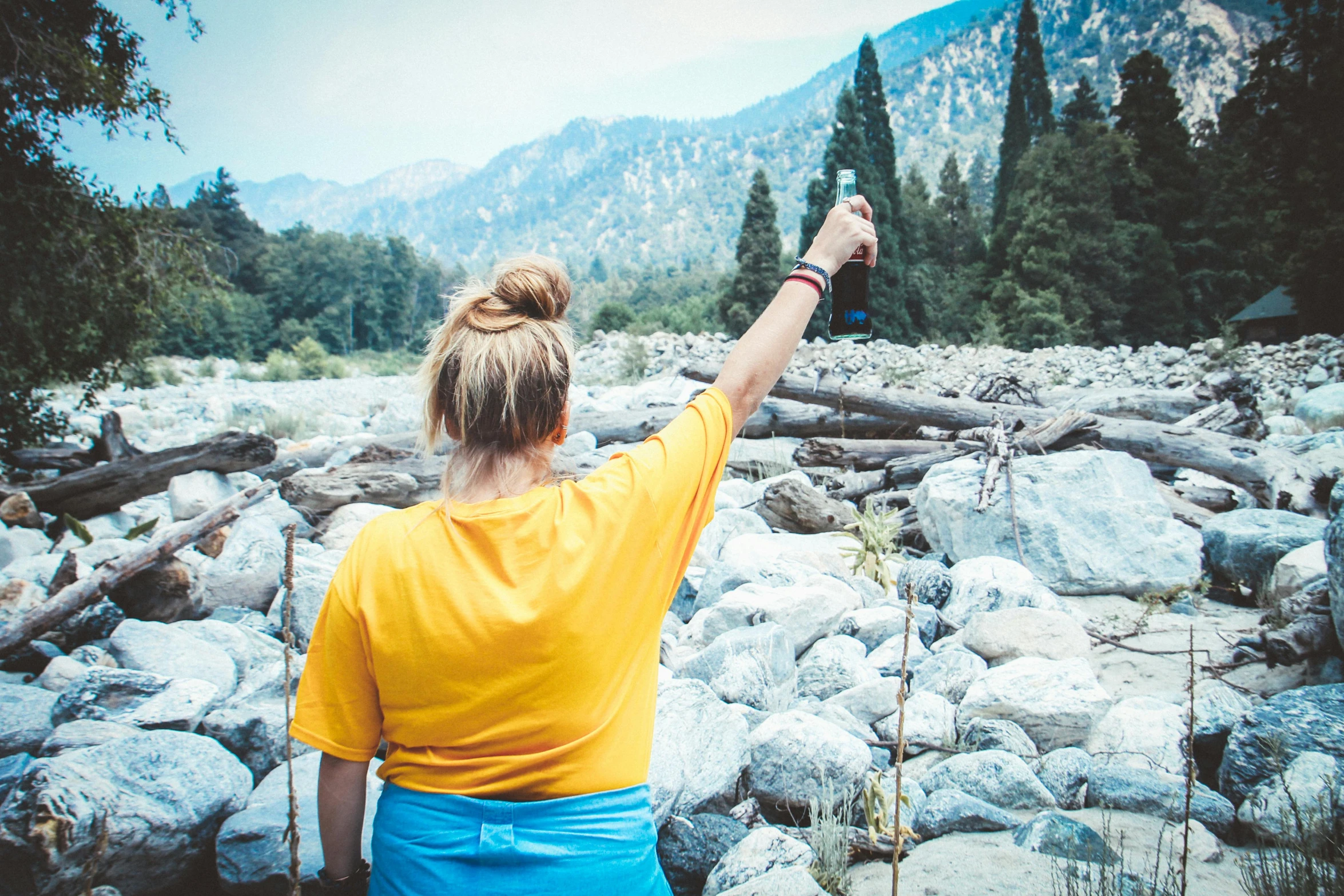 a person takes pictures of a rocky river