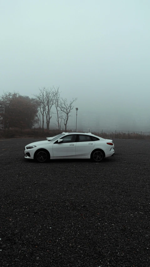 a car is parked in the parking lot on a misty day