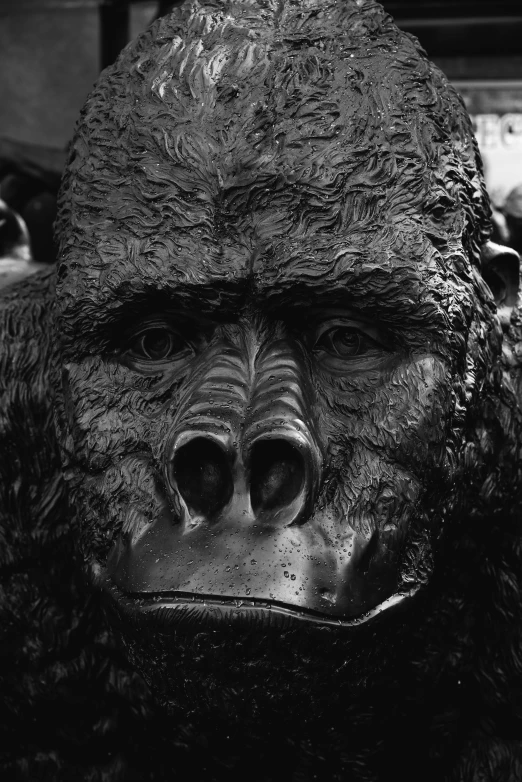 a big gorilla statue standing next to a pole