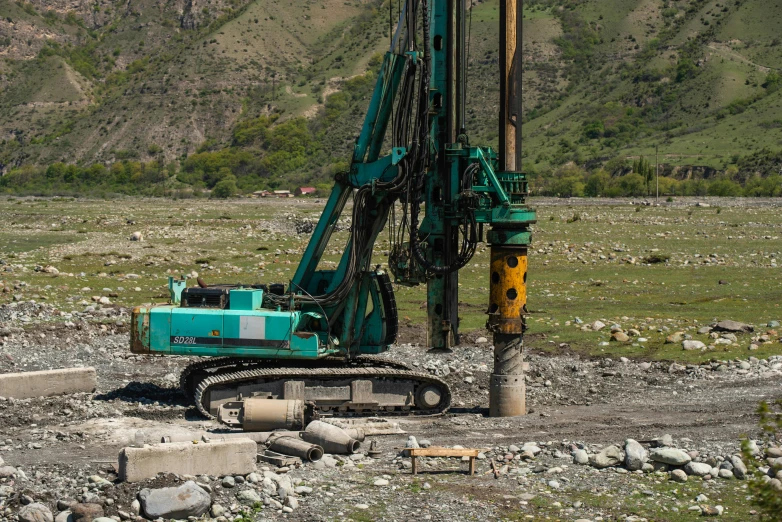 an excavator in the middle of some rocks