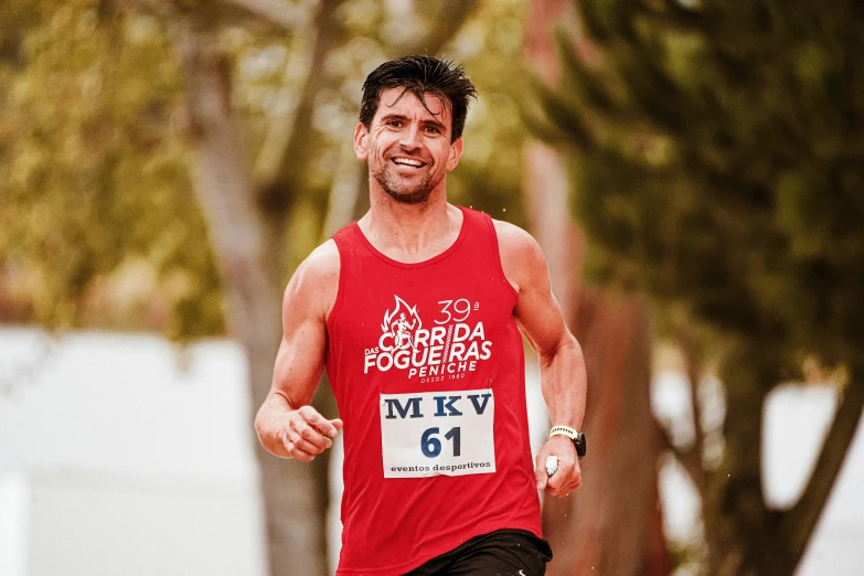 a man is running the marathon while wearing a red shirt