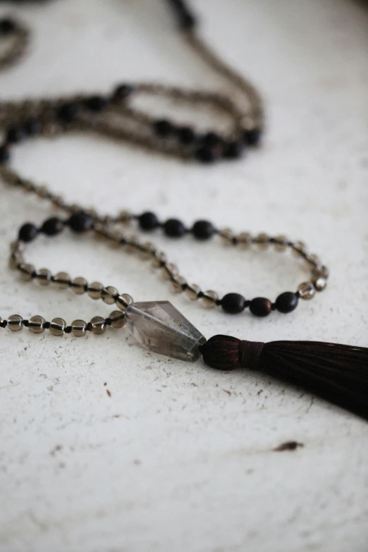 a small glass pendant on a long chain