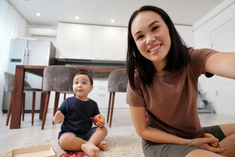 a girl and boy are eating donuts in the living room