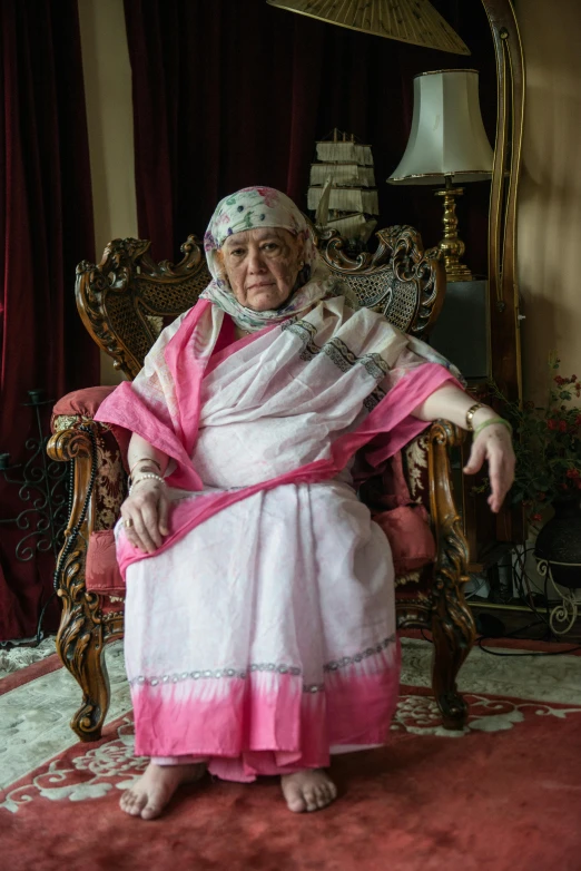 an old woman sitting on top of a chair