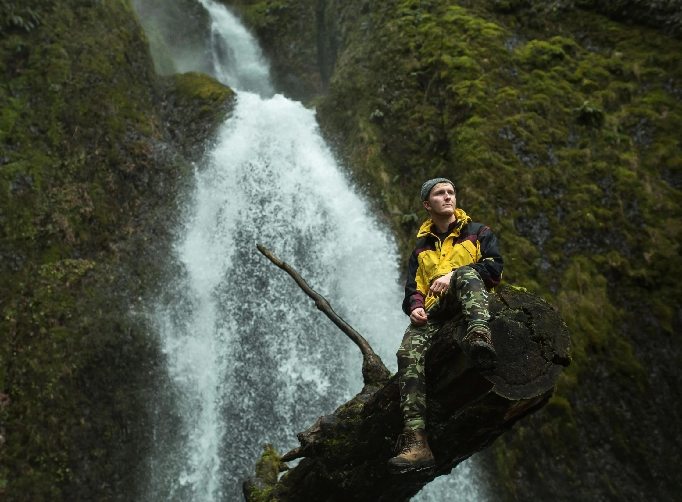 a man standing on the edge of a tall cliff