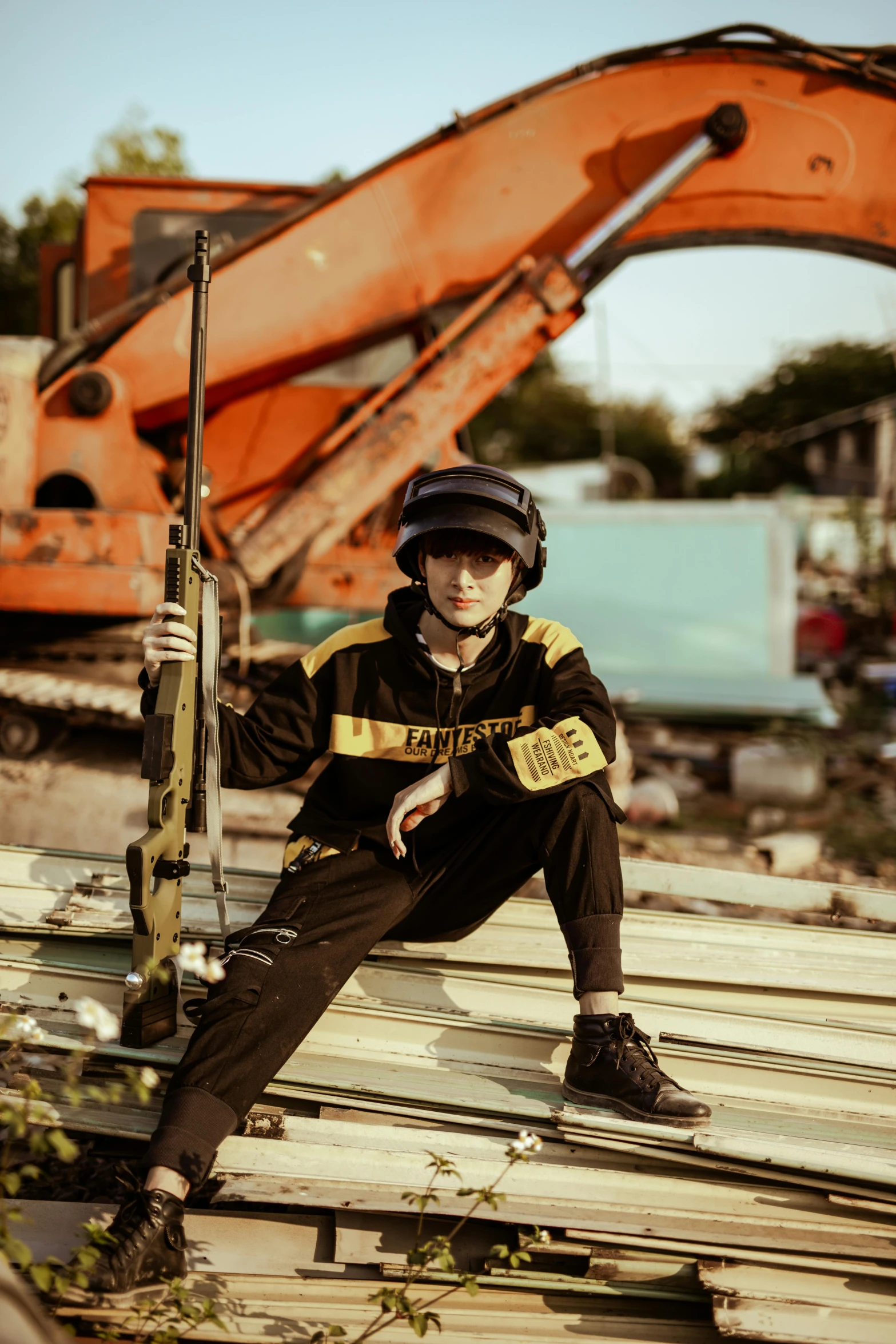 a man that is wearing a helmet sitting on a pile of pallets