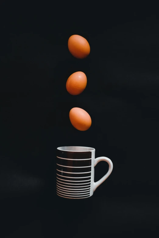 the eggs are flying out of a cup