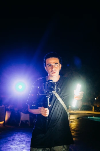 a man holding a camera and a video light
