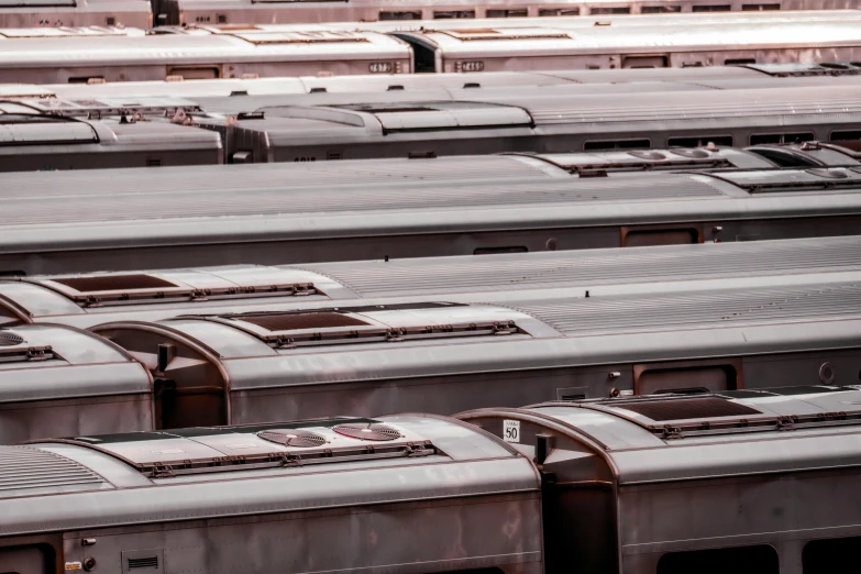 rows of train cars sit in an empty rail yard