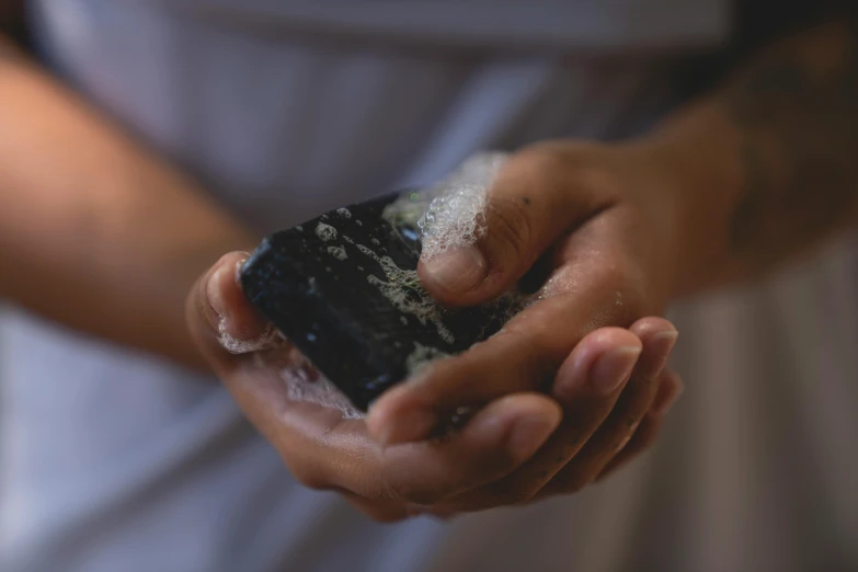 a person holding a small device with lots of sugar on it