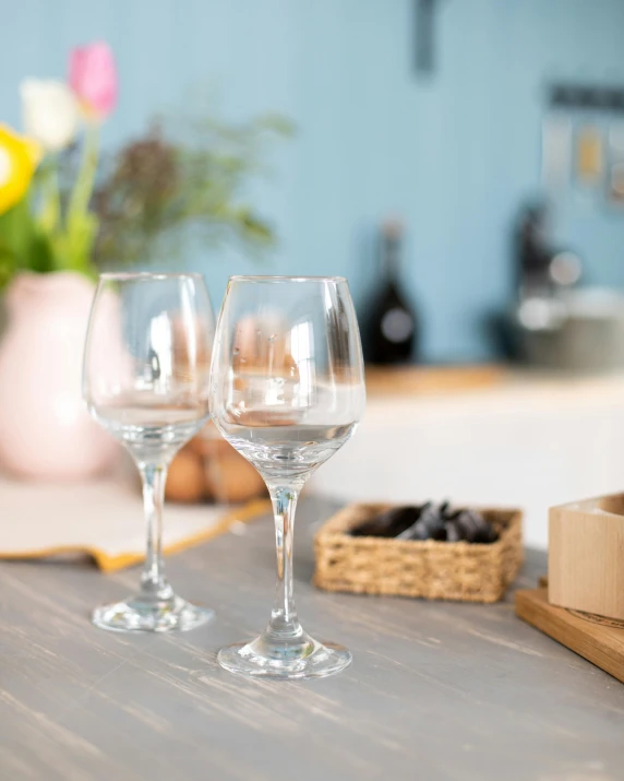 two wine glasses sitting on top of a table