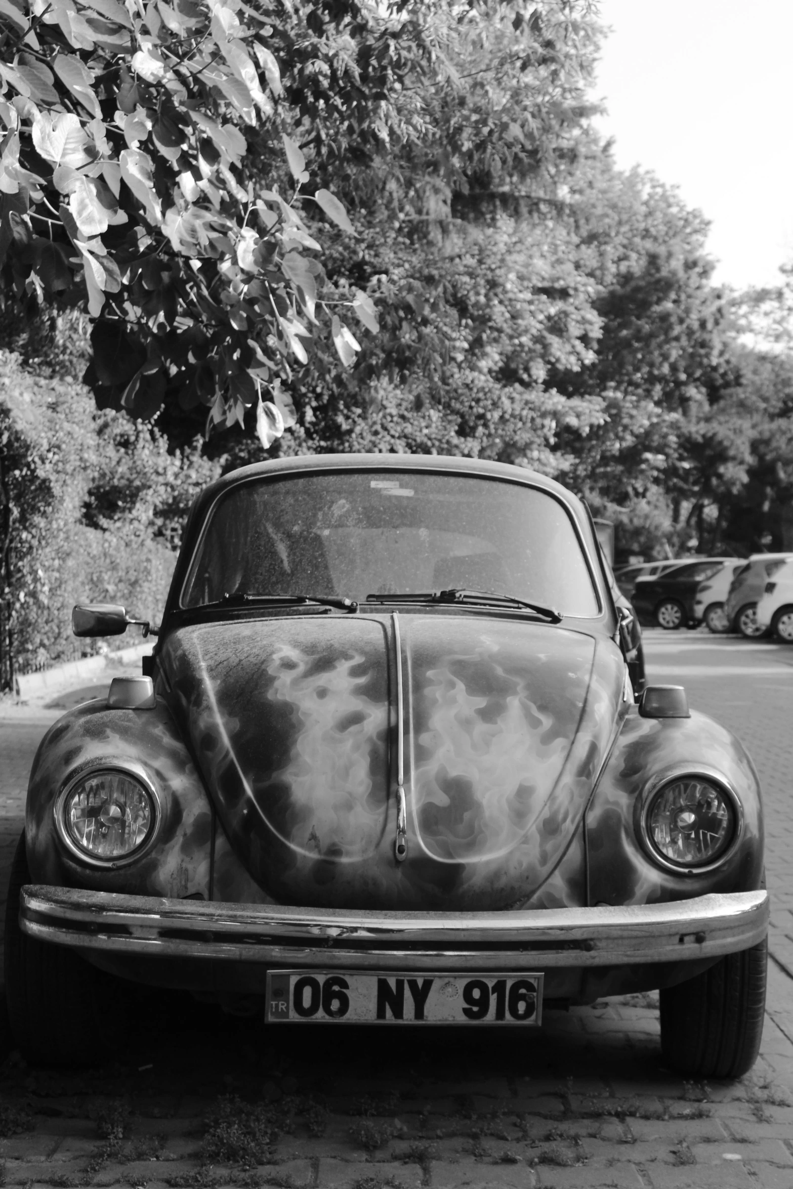 the old car is parked on the side of the road