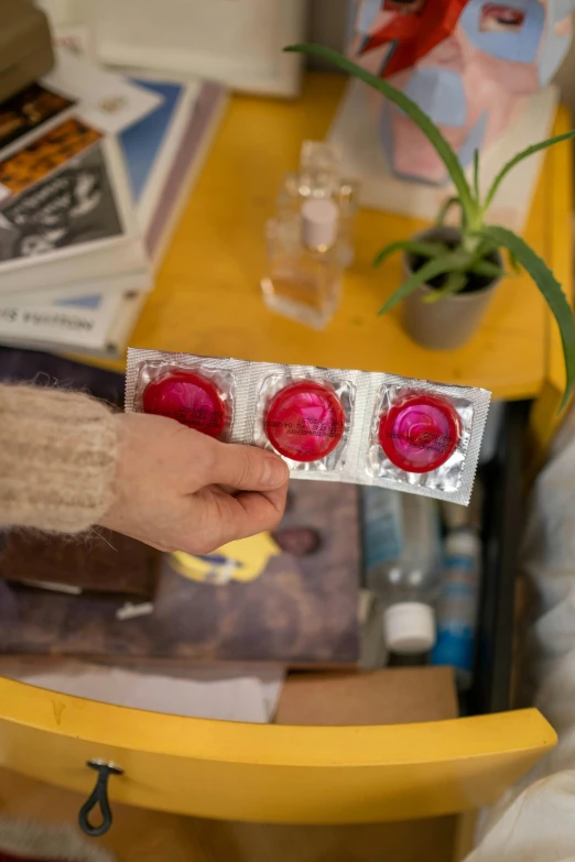 two packets of raspberry candies being held by a person