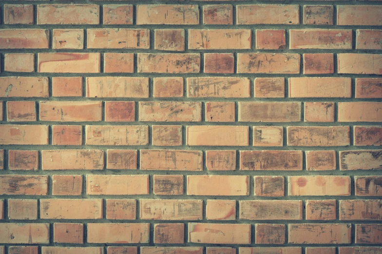 old bricks on a wall that are made of cement