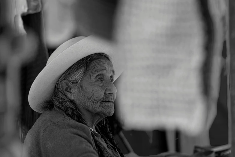 an older lady looking out the window at soing