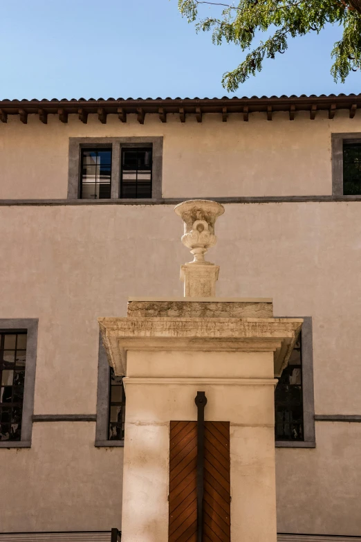 a statue is sitting on top of a white building