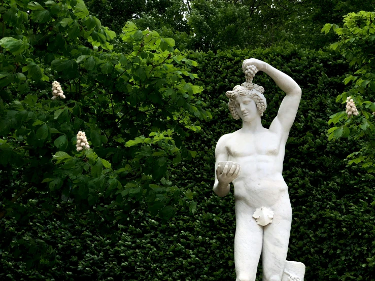 a statue of a man holding a bird on top of his hand