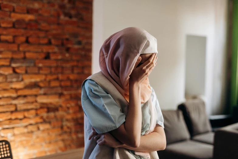 a woman standing next to a couch in a room