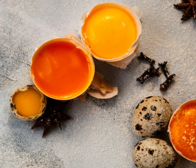 four bowls filled with sauce next to some eggs