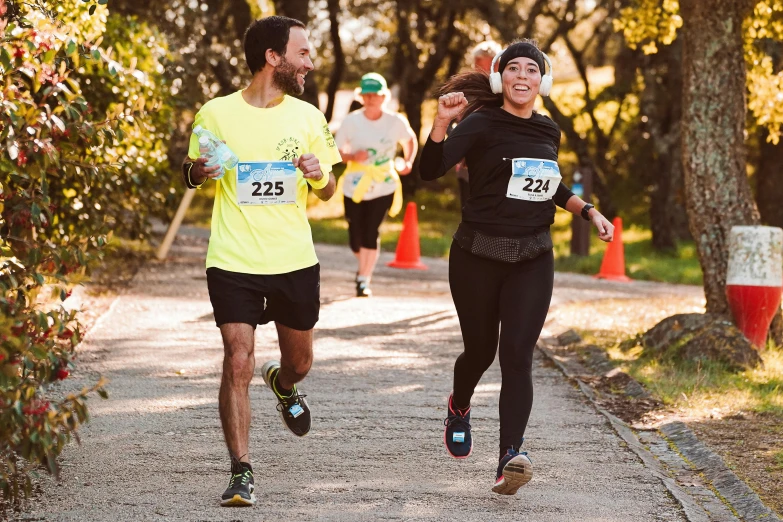 two men are running in a race on the road