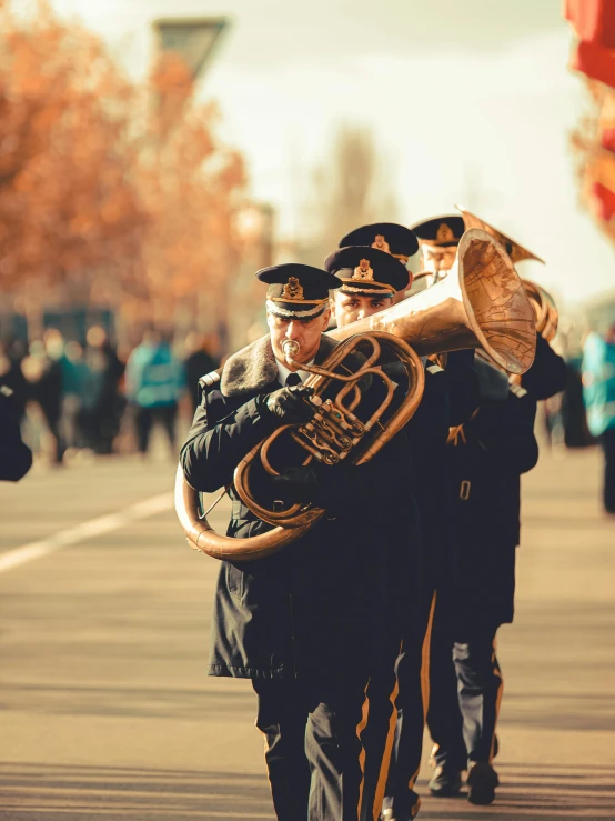 marching band in ceremonial dress walking down street