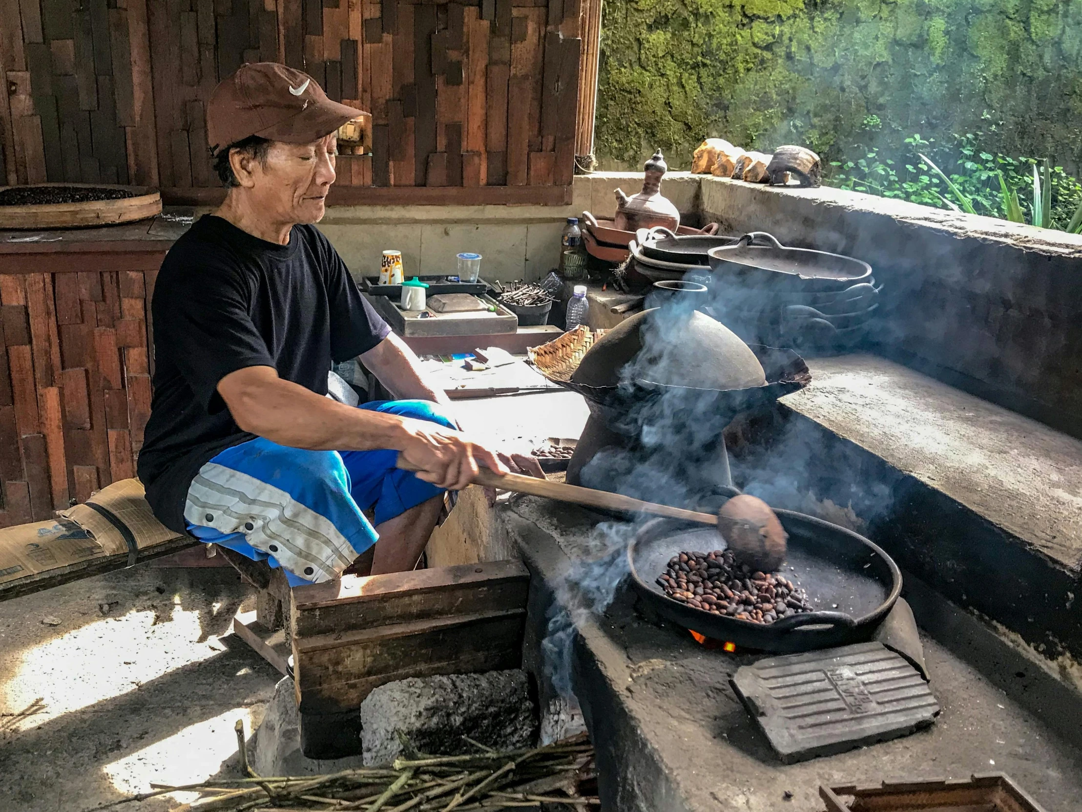 a man cooking food on top of a large grill