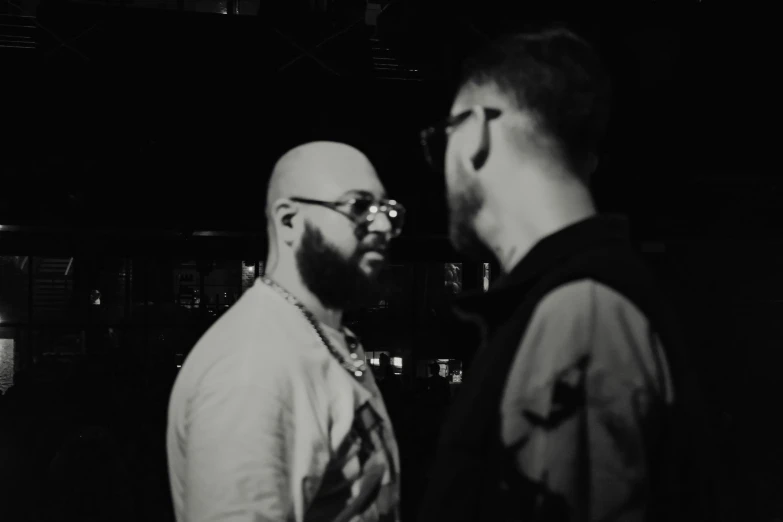 two men standing in front of a large mirror