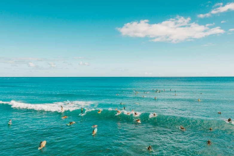 people on surfboards in the ocean surrounded by waves