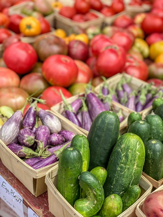 different vegetables arranged in cardboard baskets on a counter