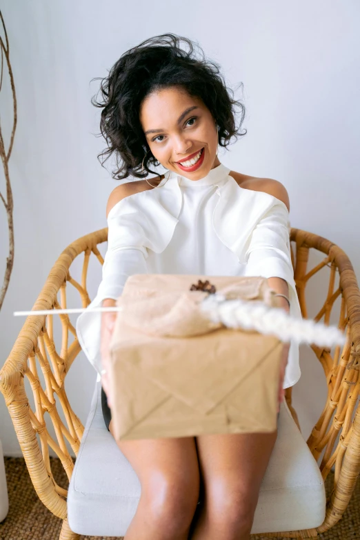 a woman with a wrapped present sitting in a chair