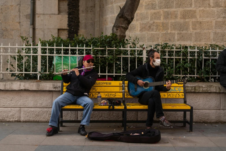 the man and woman are playing instruments in the same city