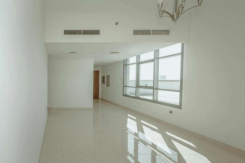 an empty room with white walls and tiled floor